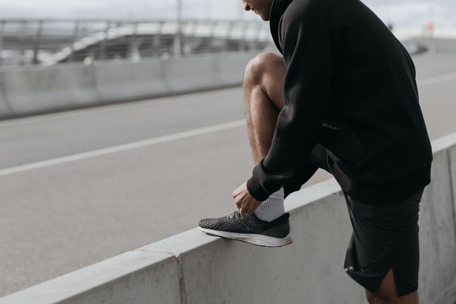 Runner tying their shoes before a run